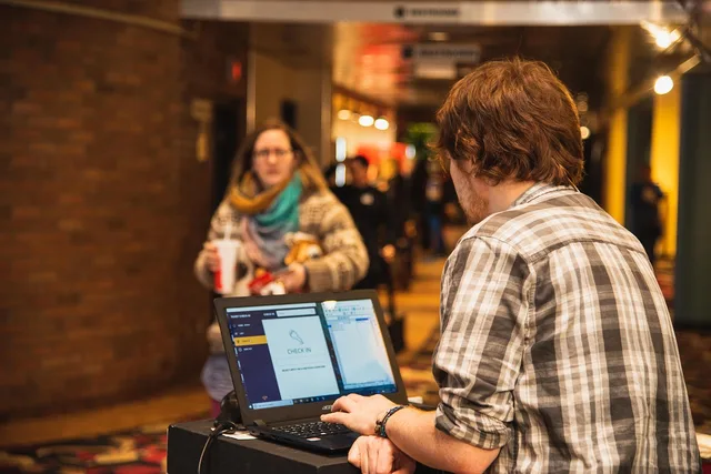 indoors, movie theatre, ticket, ticket check-in, customer, lobby, theatre, movie, computer, scanner, brown computer, brown laptop, brown movie, brown theater, brown check, ticket, lobby, lobby, scanner, scanner, scanner, scanner, scanner. Exporting tickets with attachments and conversation history
